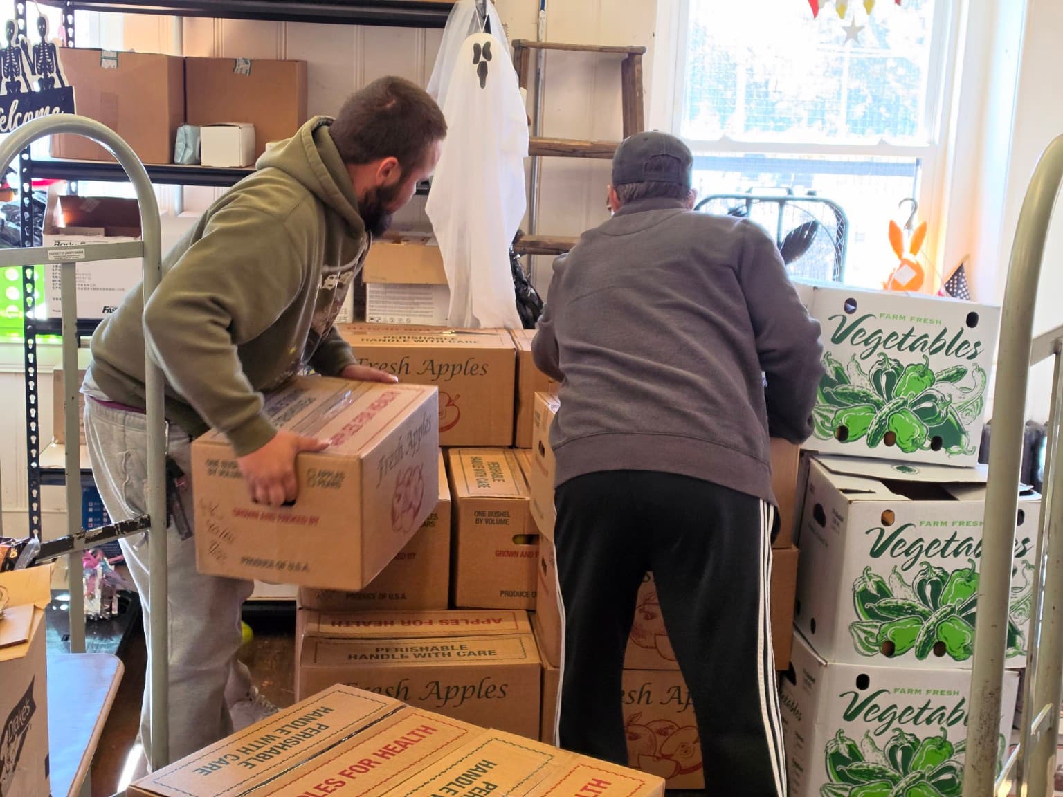 Volunteers moving boxes of produce at South Worcester Neighborhood Improvement Center